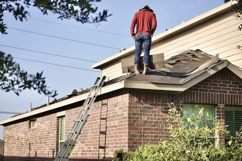 Professional roofer working on a residential roof in Arrowhead
